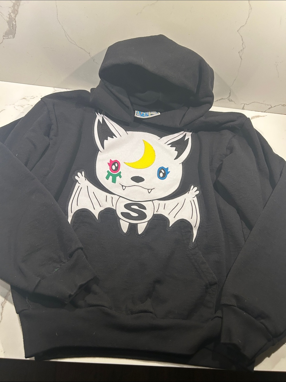 Sukamii Graphic Black Hoodie with Colorful Crest Tag